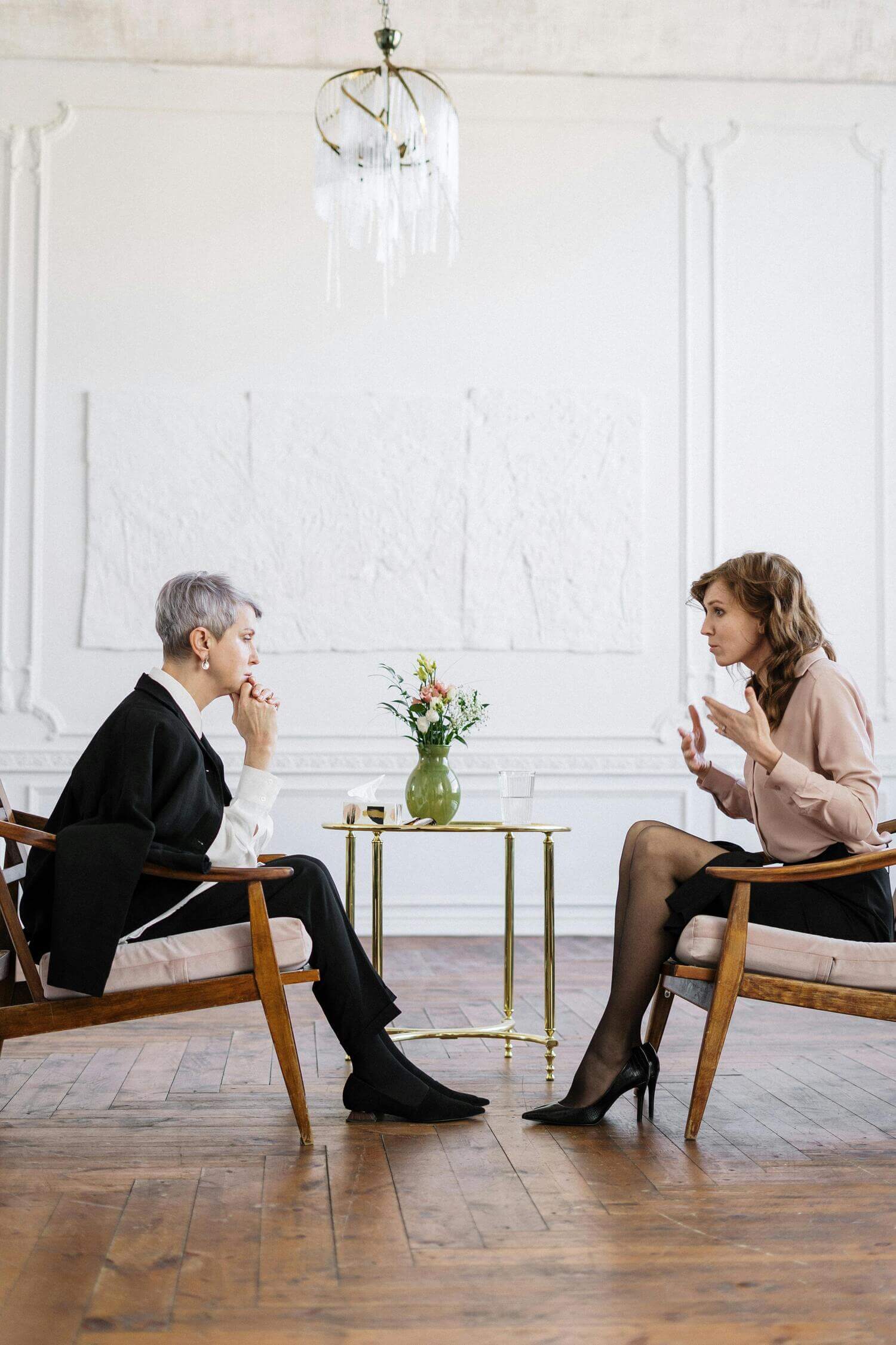 Two women having a serious conversation indoors